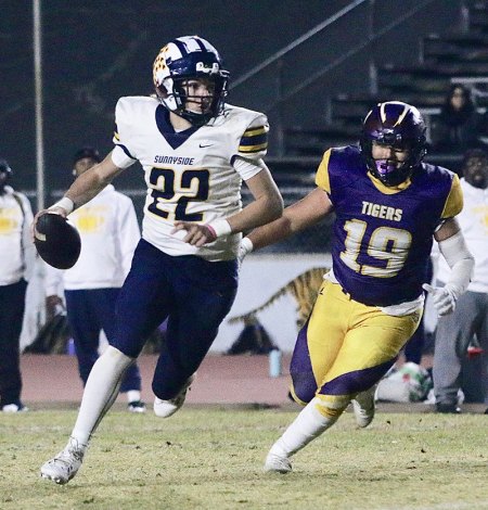 Lemoore's Gio Quintero puts pressure on 'Sunnyside quarterback Tanner Wilson.